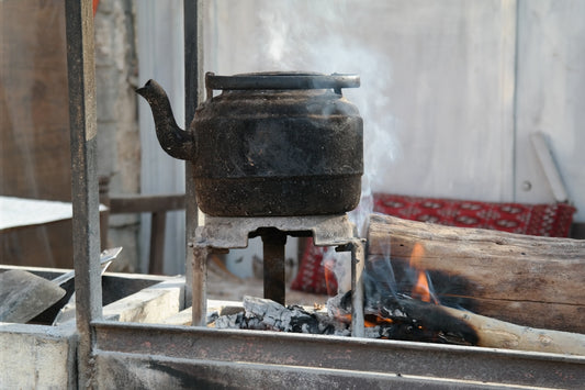 an old stove with a kettle on top of it