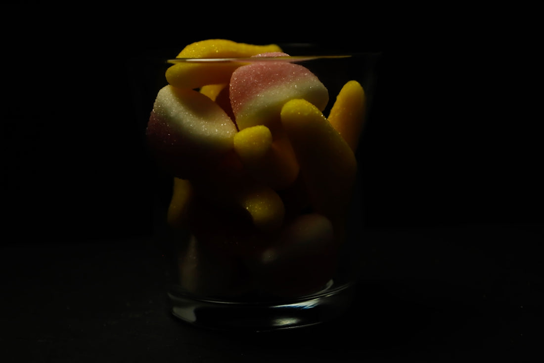 a glass filled with jelly beans on top of a table