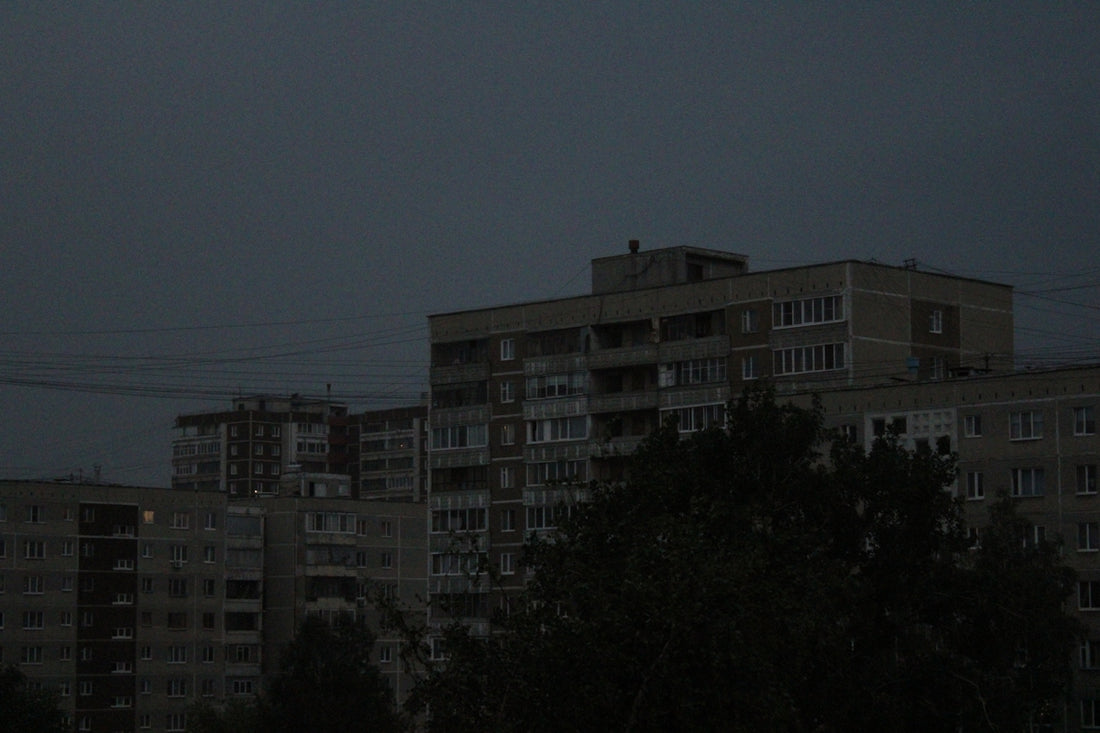 a full moon in the sky over a city