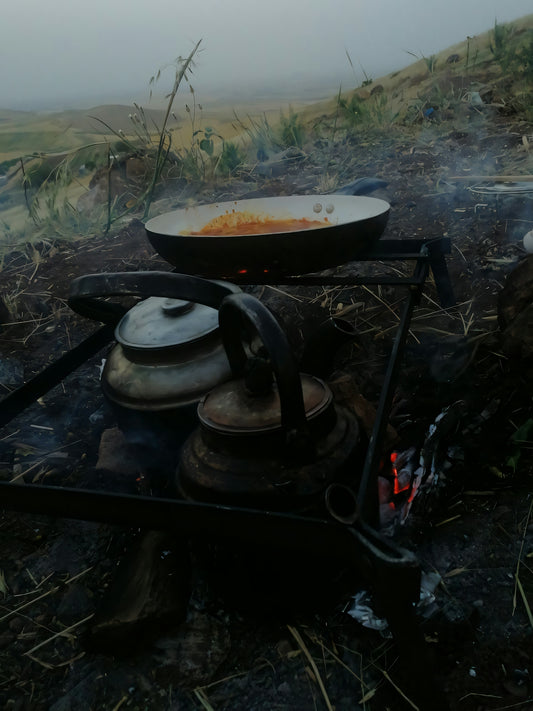 A camp stove with a pot on top of it